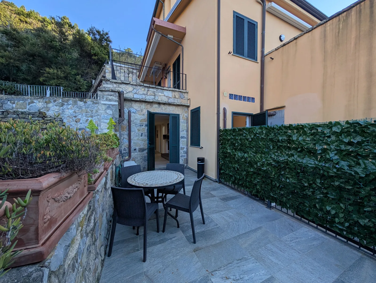 The private terrace with a table and chairs at Helios